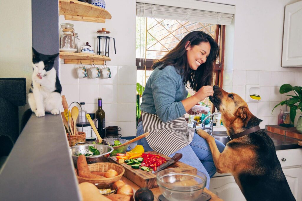 a women feeding her dog in the kitchen